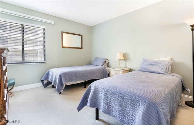 bedroom featuring carpet floors and baseboards