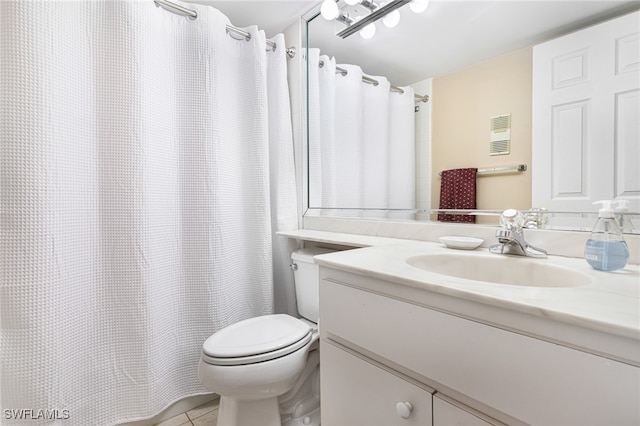 bathroom with vanity, toilet, and tile patterned flooring