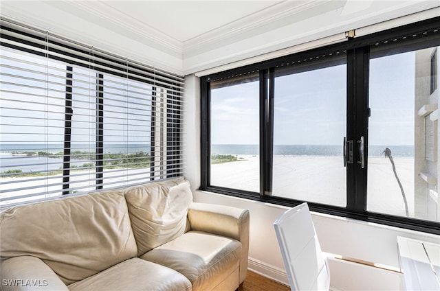 living room featuring ornamental molding and a water view