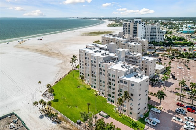 birds eye view of property featuring a water view, a view of the beach, and a city view