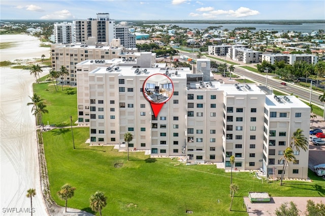 drone / aerial view with a city view and a water view