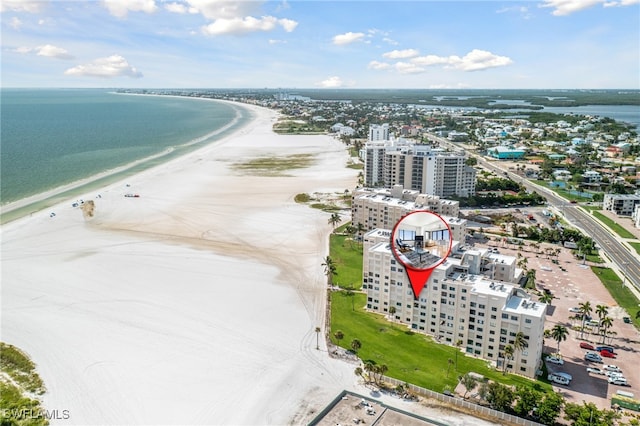 aerial view with a city view, a water view, and a beach view