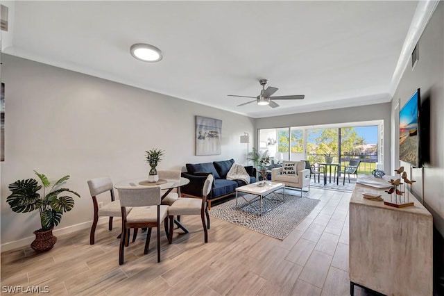 living room featuring ceiling fan and crown molding