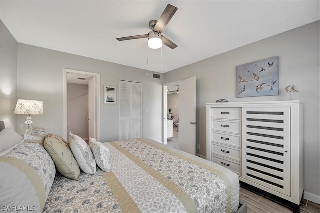 bedroom with ceiling fan, a closet, and light hardwood / wood-style flooring