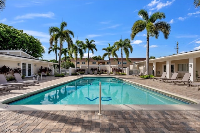 view of swimming pool featuring a patio area and french doors