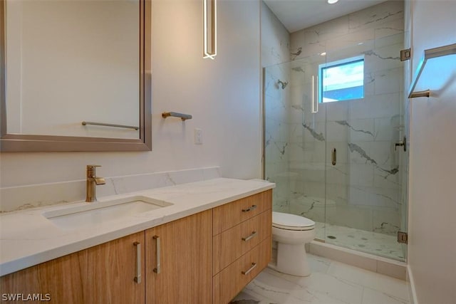 bathroom featuring toilet, marble finish floor, a marble finish shower, and vanity