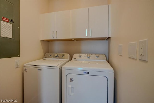 laundry room featuring cabinets and separate washer and dryer