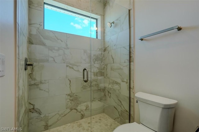 full bath with a marble finish shower and toilet