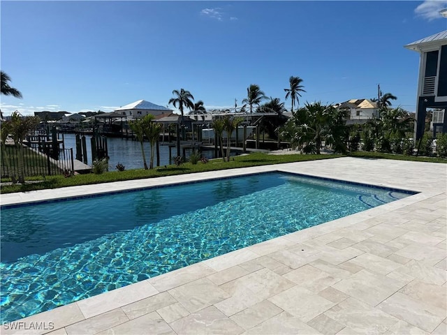 view of swimming pool featuring a water view and a patio