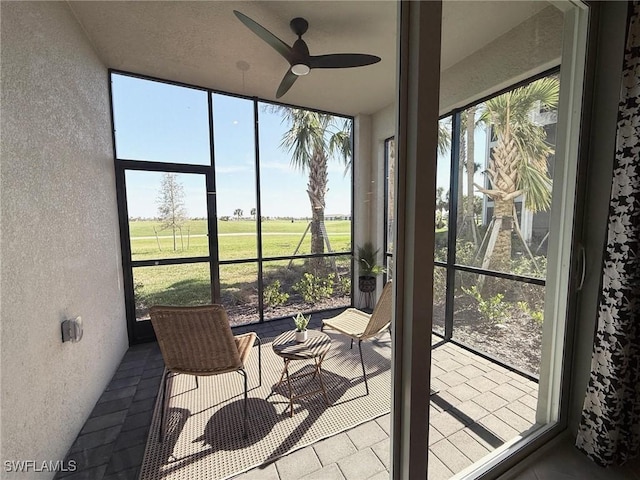 sunroom featuring ceiling fan