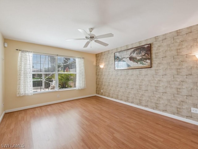 unfurnished room featuring ceiling fan and hardwood / wood-style flooring