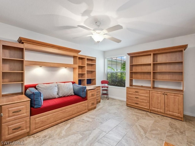 interior space with ceiling fan