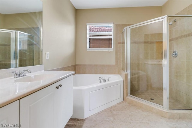 full bath with a bath, a stall shower, tile patterned flooring, and vanity