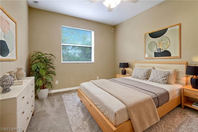 bedroom featuring baseboards, a ceiling fan, and light colored carpet