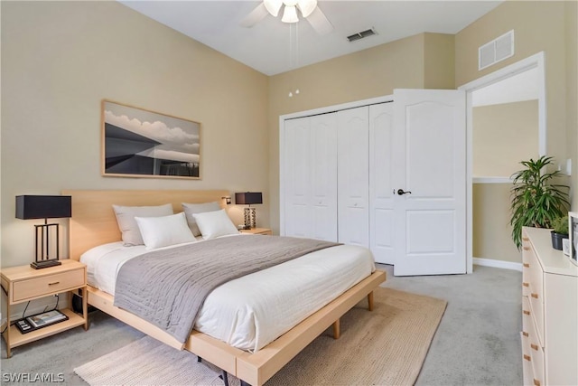 bedroom with light carpet, a closet, visible vents, and baseboards