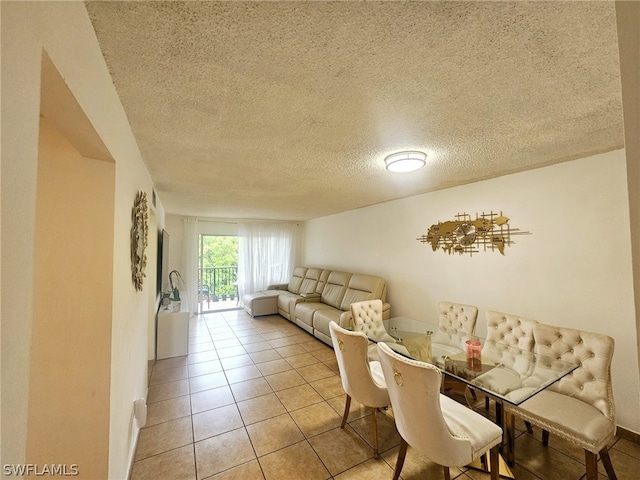 dining room with light tile patterned floors and a textured ceiling