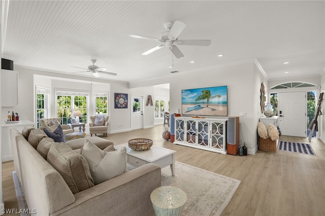 living room with light wood-type flooring, ceiling fan, and ornamental molding