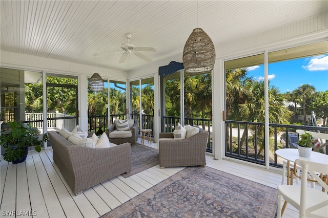 sunroom featuring ceiling fan