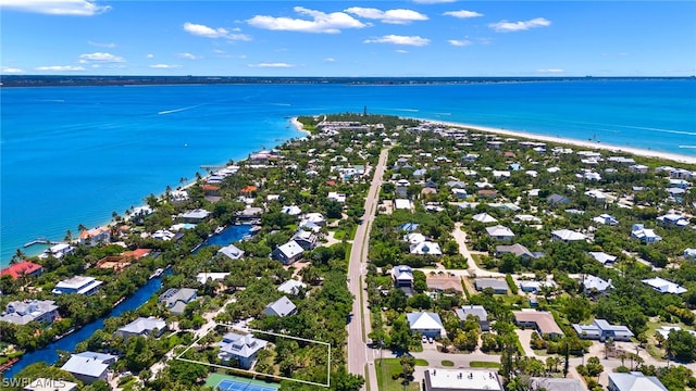 birds eye view of property featuring a view of the beach and a water view