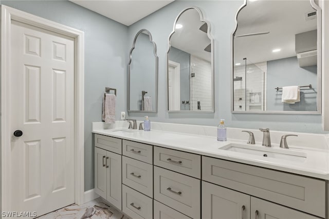 bathroom featuring vanity and a shower with shower door