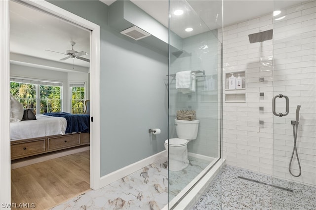 bathroom featuring ceiling fan, toilet, and an enclosed shower