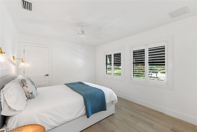 bedroom with ceiling fan and light hardwood / wood-style flooring