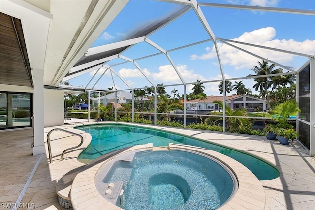 view of pool with glass enclosure, a patio area, and an in ground hot tub