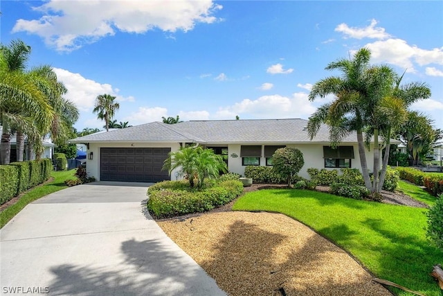 single story home with a garage and a front lawn