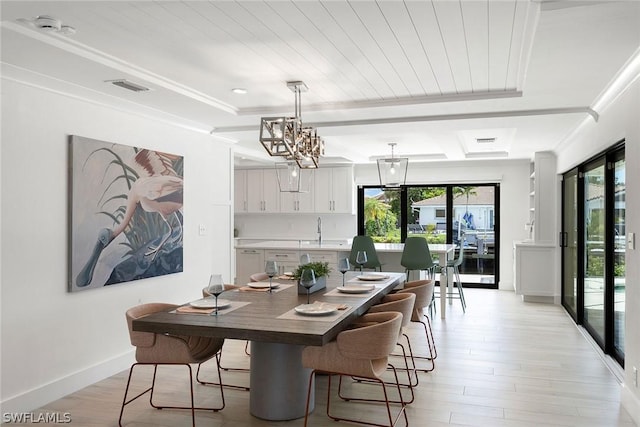 dining space featuring sink, light hardwood / wood-style flooring, crown molding, a chandelier, and wood ceiling