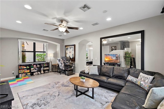 living room with hardwood / wood-style floors and ceiling fan