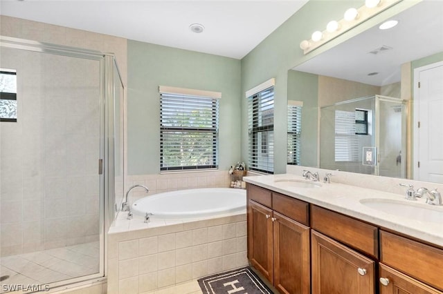 bathroom featuring tile patterned flooring, vanity, and separate shower and tub