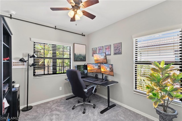 office featuring carpet floors, a wealth of natural light, and ceiling fan