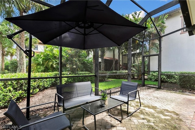 view of patio with glass enclosure and an outdoor hangout area