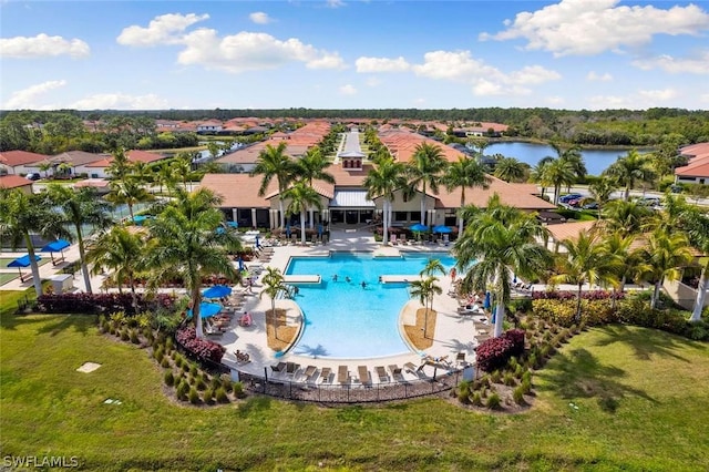 view of pool with a patio area and a water view