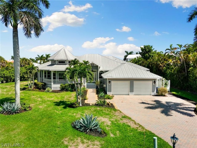 view of front of property featuring a garage and a front lawn