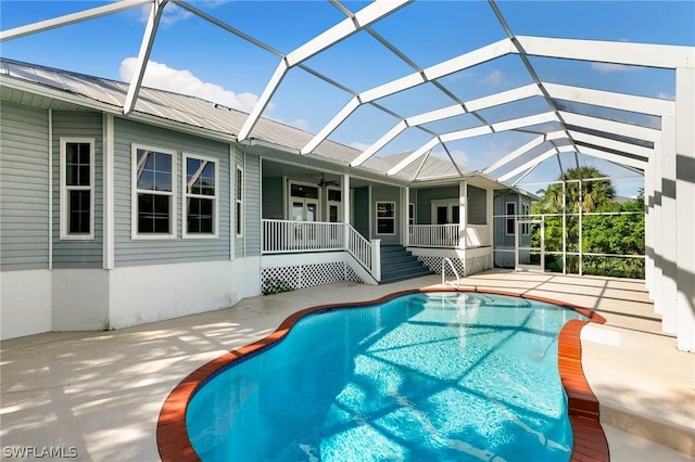 view of pool featuring a lanai, a patio area, and ceiling fan