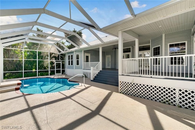 view of pool with ceiling fan, a lanai, and a patio