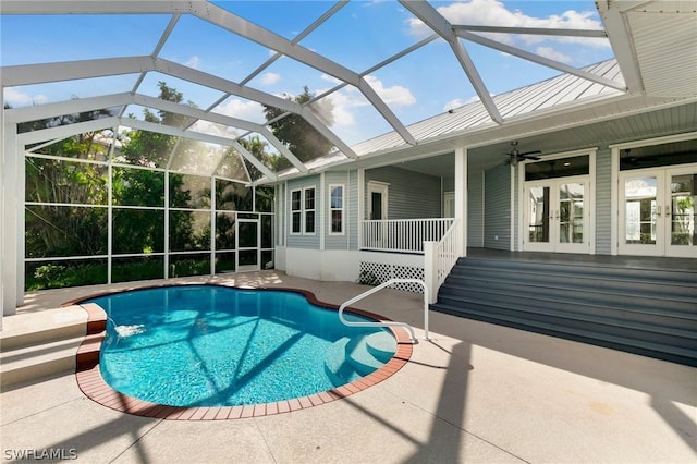 view of swimming pool with french doors, a patio area, ceiling fan, and a lanai