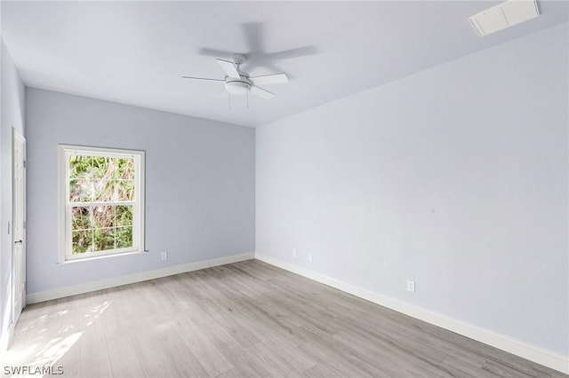 empty room featuring ceiling fan and light hardwood / wood-style floors