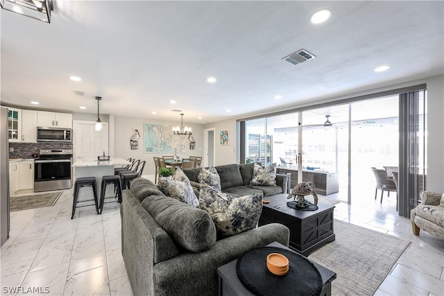 living room with a wall of windows and a chandelier