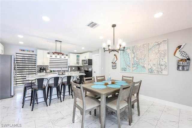 dining space with an inviting chandelier