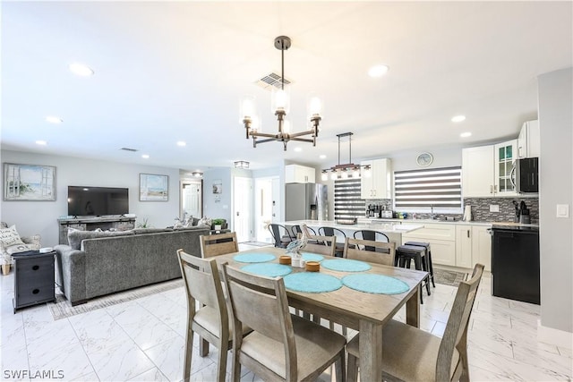 dining area with a chandelier and sink