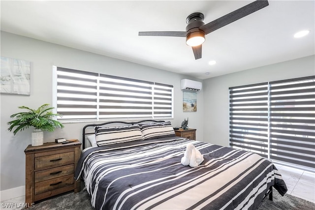 bedroom featuring a wall mounted AC and ceiling fan