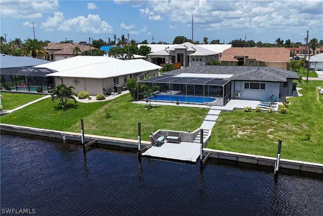 back of house with a lanai, a lawn, a patio, and a water view