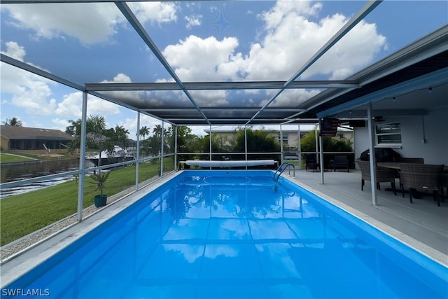 view of pool featuring a lanai, a yard, and a patio area