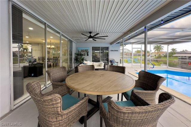 sunroom / solarium featuring ceiling fan