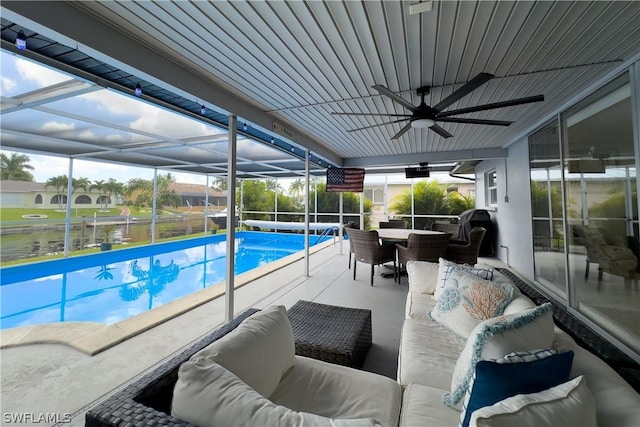 view of swimming pool featuring a lanai, outdoor lounge area, a patio, and a water view