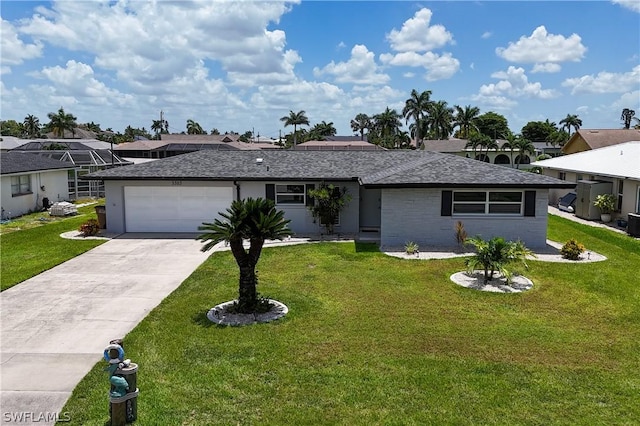 ranch-style home featuring a garage, a front lawn, and central air condition unit