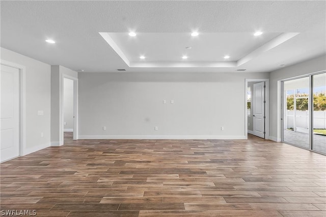 unfurnished room featuring a raised ceiling