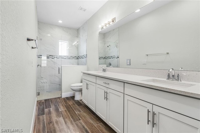 bathroom with vanity, toilet, and an enclosed shower